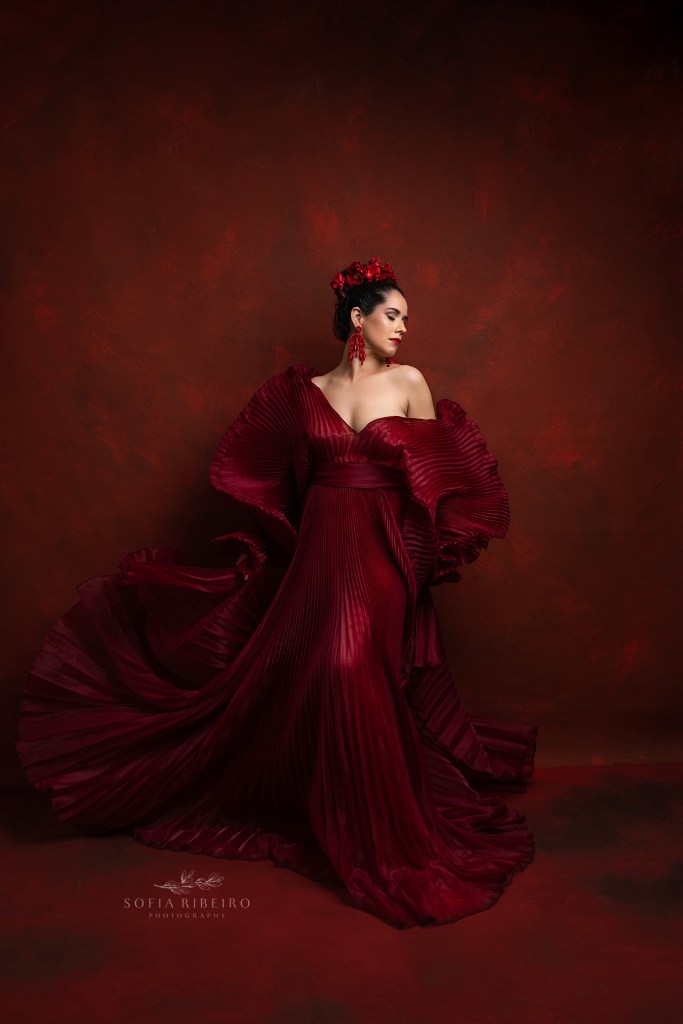 nj headshot and branding photographer creates a dramatic portrait in red with movement in the pleated gown