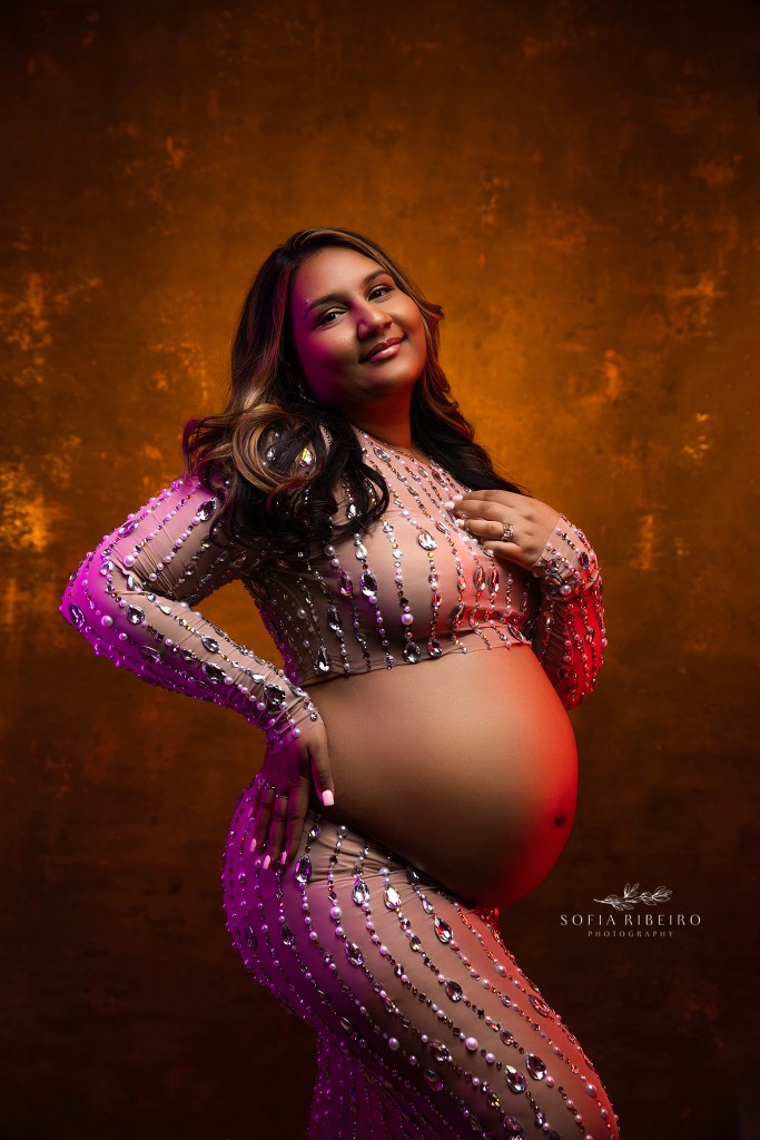 north brunswick maternity photographer poses an expectant mom in a dramatic glowing portrait with gel lighting.