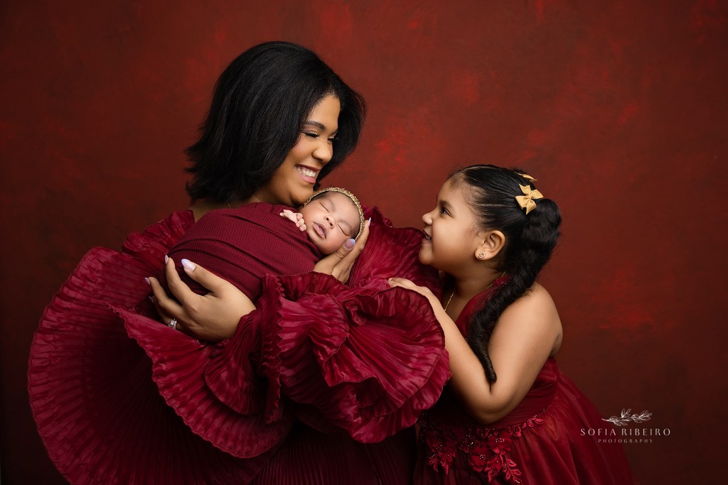 a gorgeous portrait of mom and her daughters in red