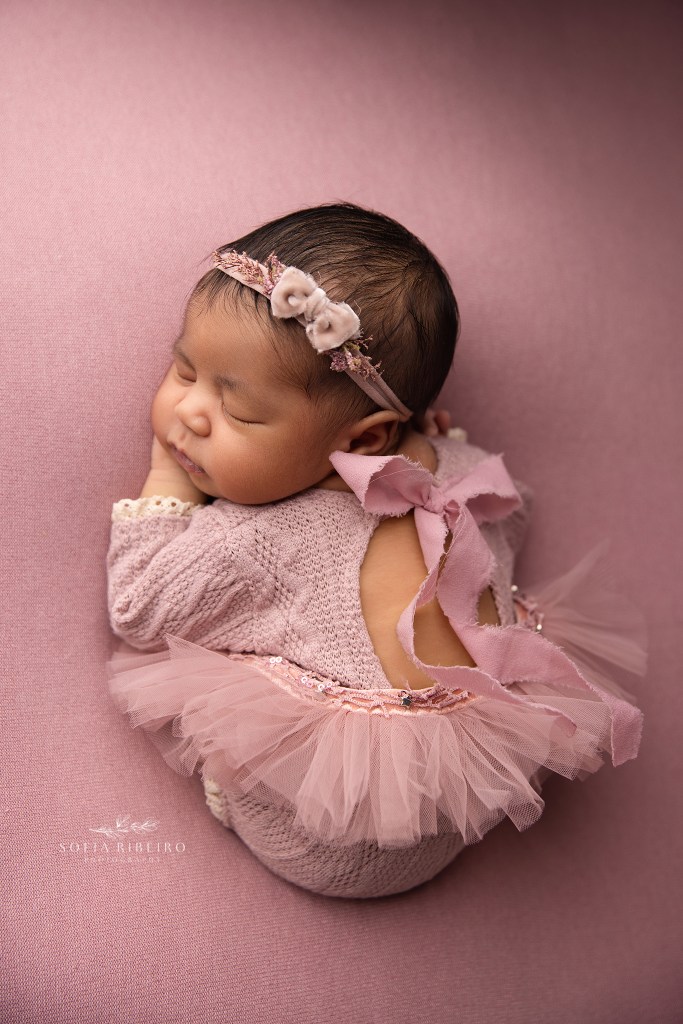 a nj photographer captures a sweet baby girl in a pink tutu outfit for newborn photos