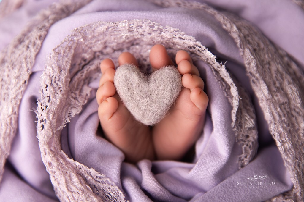 sussex nj newborn photographer captures delicate baby details like little toes cradling a heart