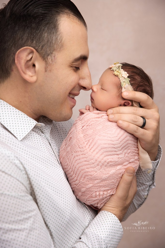 dad takes a photo nose to nose with his baby girl