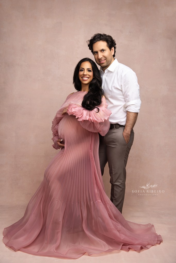 mom and dad are all smiles for a pregnancy portrait in nyc