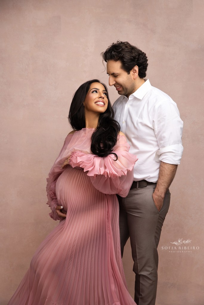 mom and dad share a sweet moment looking at each other for maternity portraits