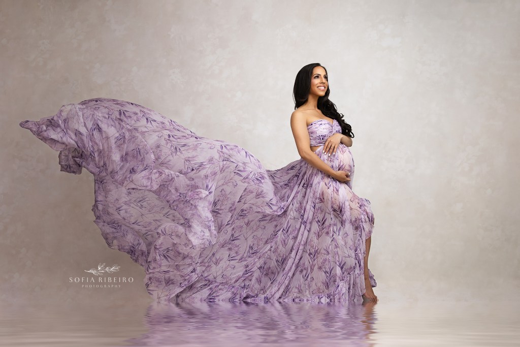 a billowing purple gown flows behind mom for a maternity portrait