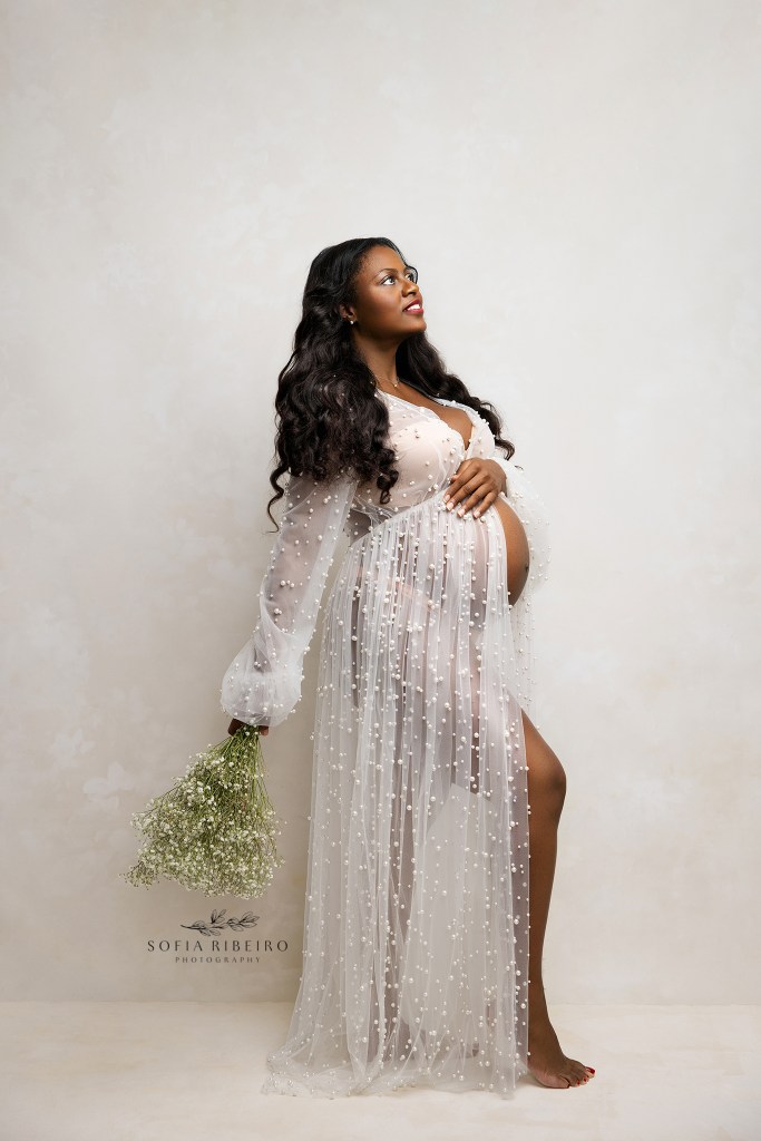 an expectant mom poses effortlessly in a pearl baby bump showing dress for a maternity portrait in secaucus nj