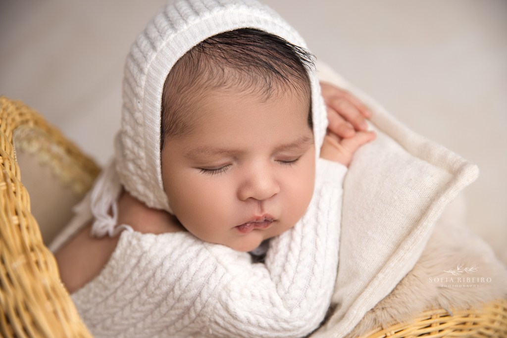 nj newborn photographer captures a closup of a newborn in a pram prop