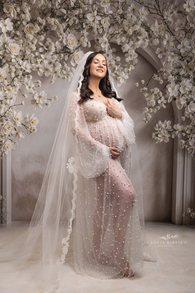 Emotional portrait of mom-to-be wearing her bridal veil, tying past to present at a budd lake nj maternity studio