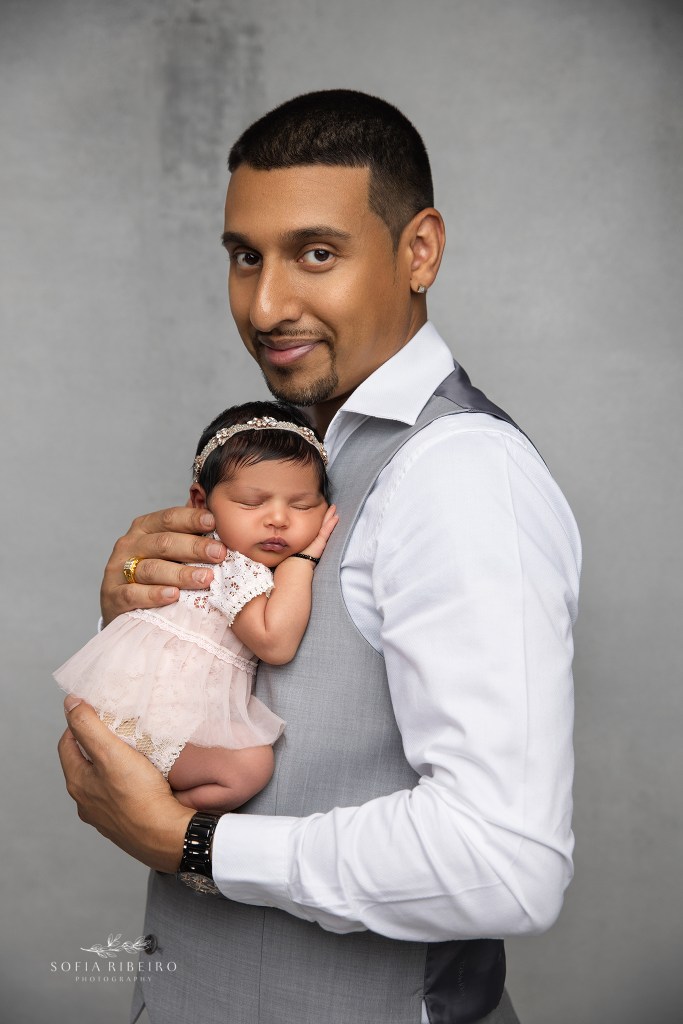 a portrait of a dad and his newest baby girl in east brunswick nj