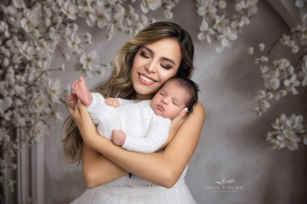 Family portrait with newborn baby boy cradled in mom's arms