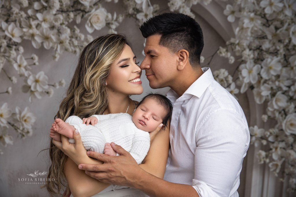 Family portrait with newborn baby boy cradled in his parents’ arms in essex county nj 