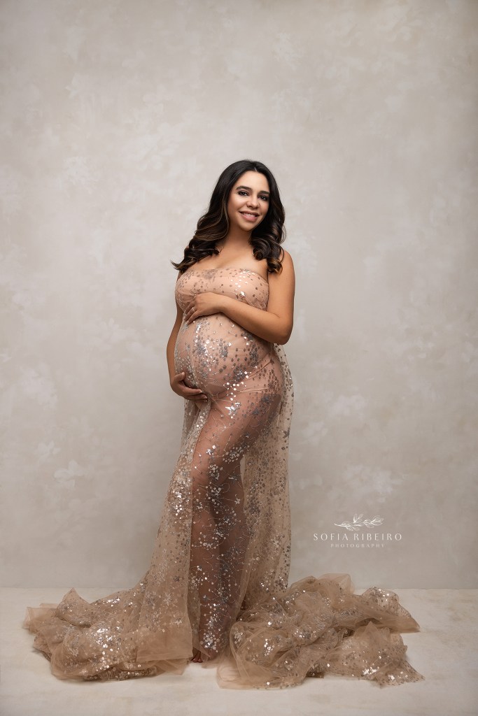 sparkling sheer fabric is draped around an expectant mom during a maternity session in hillside nj
