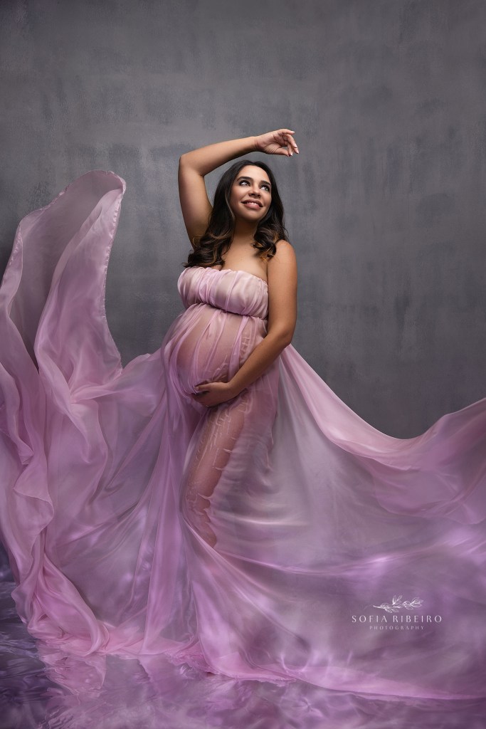 hillside nj maternity photographer creates a dramatic maternity portrait with reflective light and flowing fabric