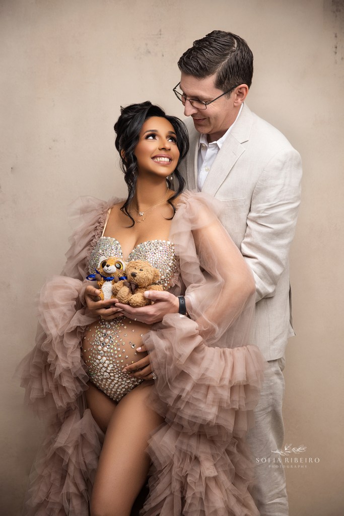 Couple embracing during a neutral studio maternity session in Princeton NJ.