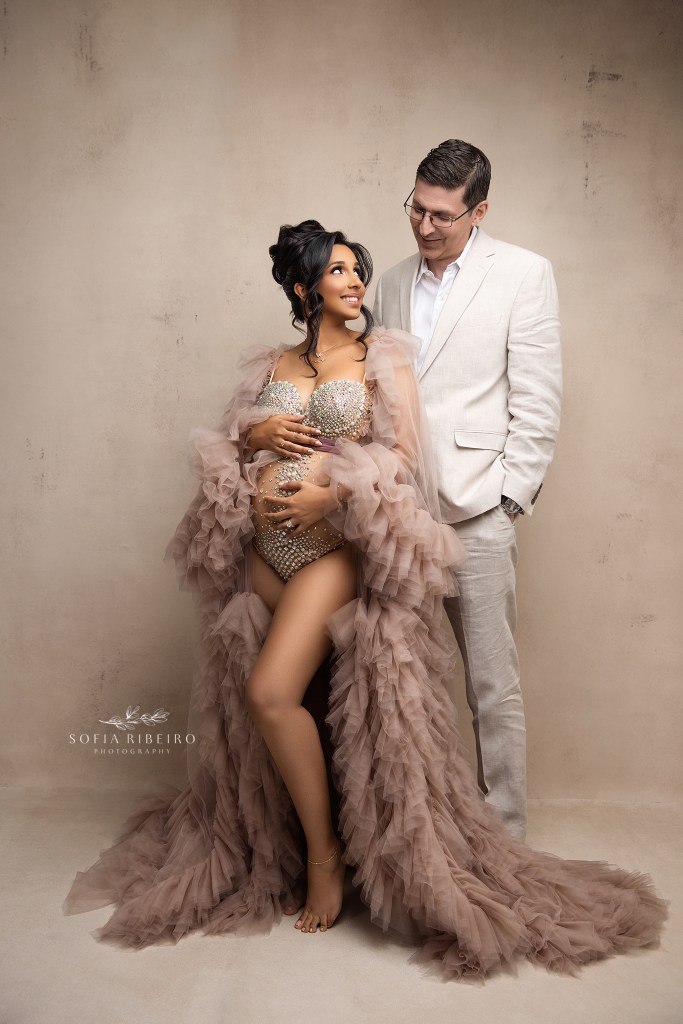 Couple’s maternity portraits filled with tenderness by an nj maternity photographer. Dad looks lovingly at mom while cradling her belly.