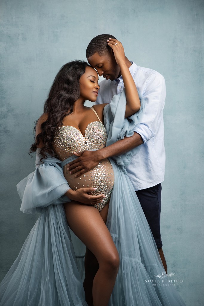 a couple poses together, embracing the baby bump during a maternity session with a morris plains nj maternity photographer