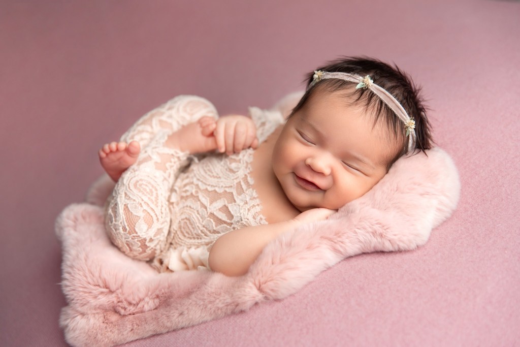 nj newborn photographer captures a smiling newborn portrait in studio
