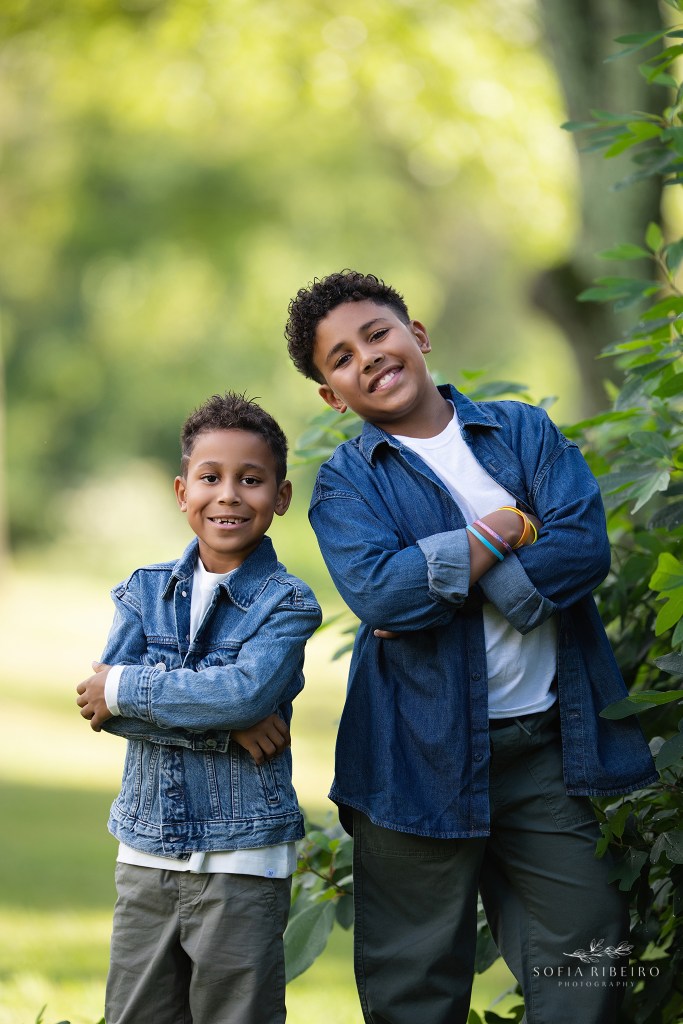 cranford family photographer captures two brothers being silly together in greenery outdoors
