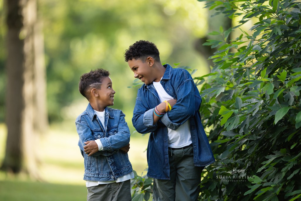 cranford family photographer captures two brothers being silly together in greenery outdoors