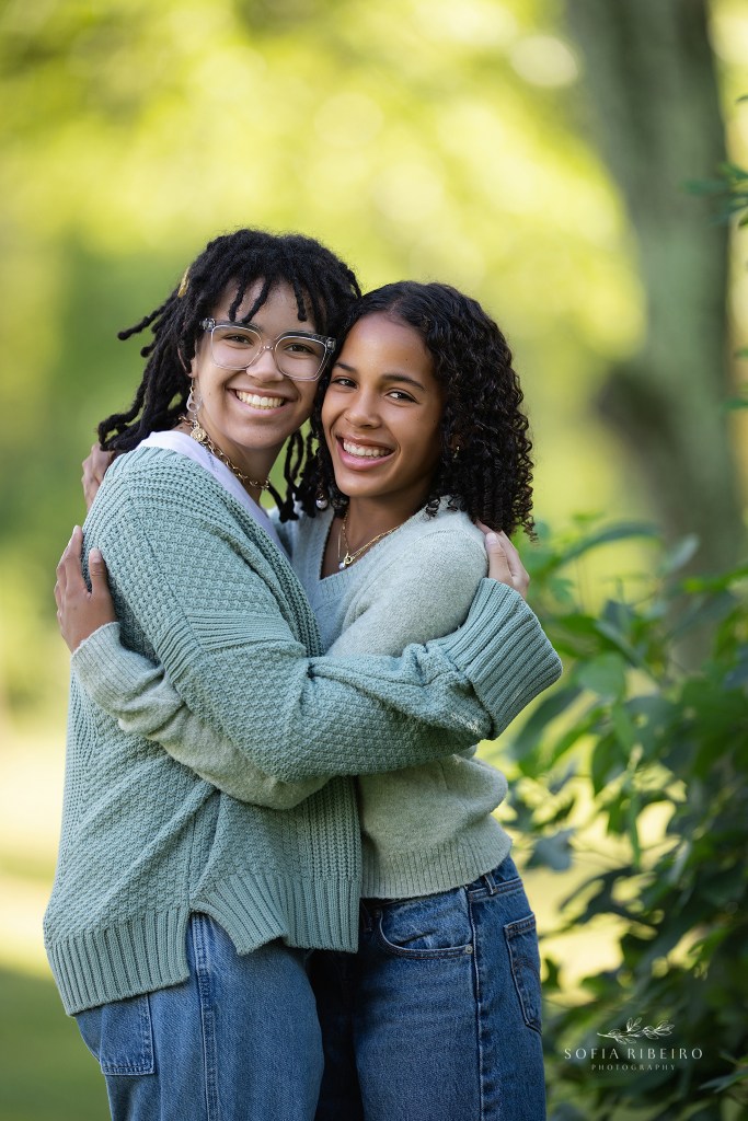 cranford family photographer captures two sisters in greenery outdoors