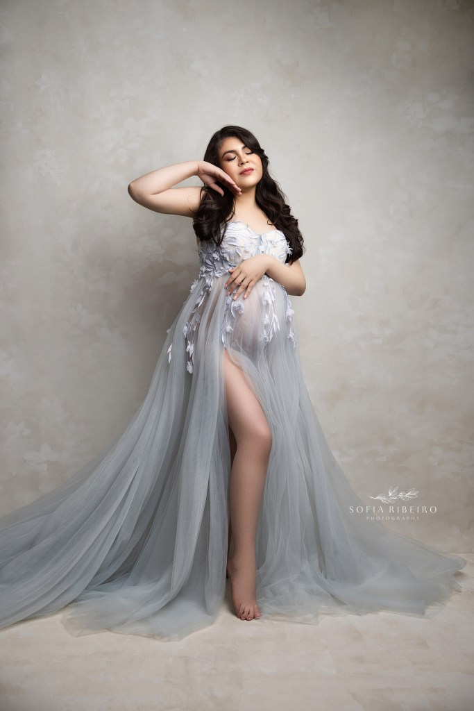 soft blue hues enhance moms growing baby bump in this ethereal maternity portrait