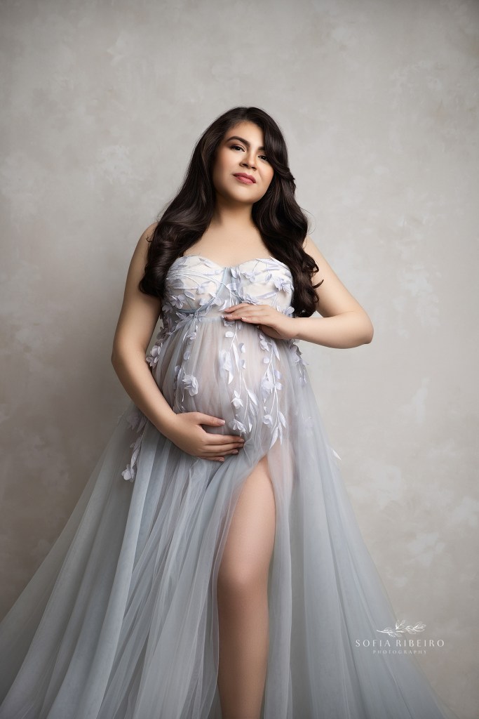 mom to be cradles her baby bump for a maternity portrait