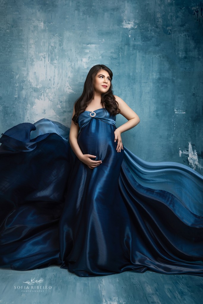 flowing fabrics emphasize mom to be's growing baby bump in an edgewater nj maternity photography studio