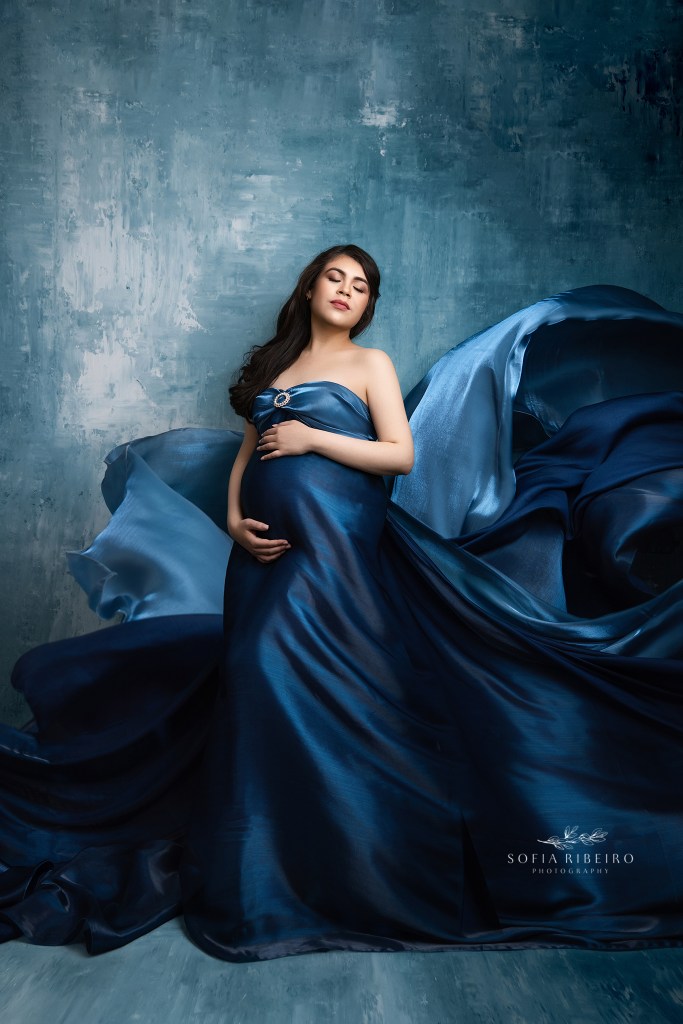 flowing fabrics emphasize mom to be's growing baby bump in an edgewater nj maternity photography studio