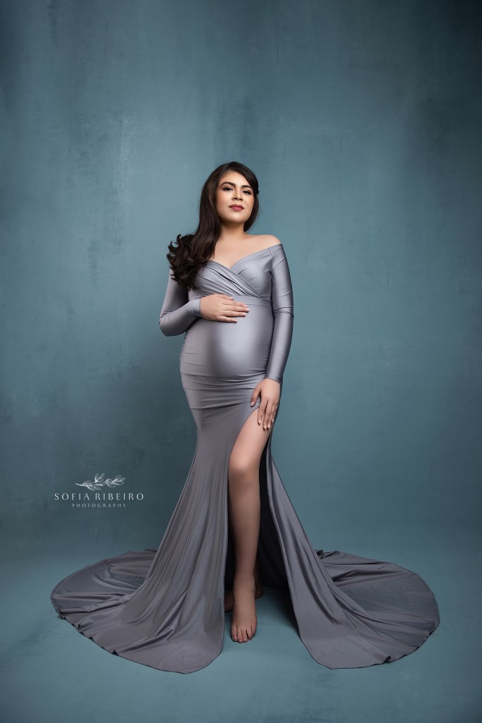 an elegant silver gown hugs mom's baby bump for a maternity portrait in edgewater nj