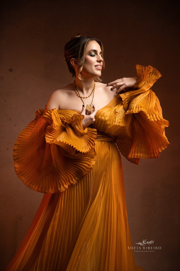 a sensual but demure image showcasing gold jewelry against a golden gown for a 40th birthday portrait in a short hills nj photo shutio