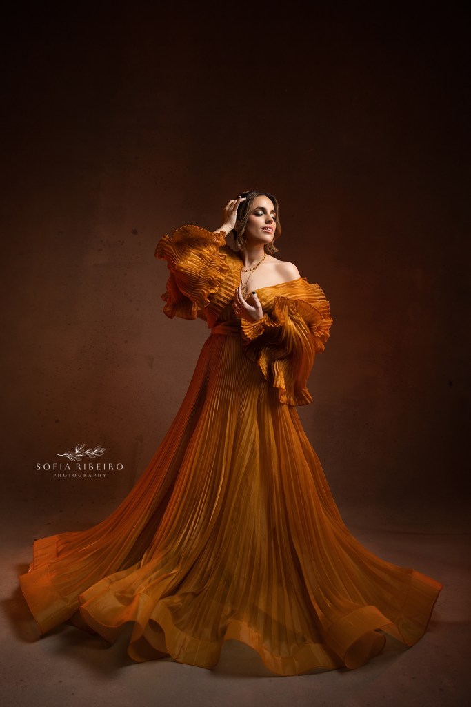 a dramatic golden gown with dramatic lighting for a full body shot during a 40th birthday photoshoot in short hills nj
