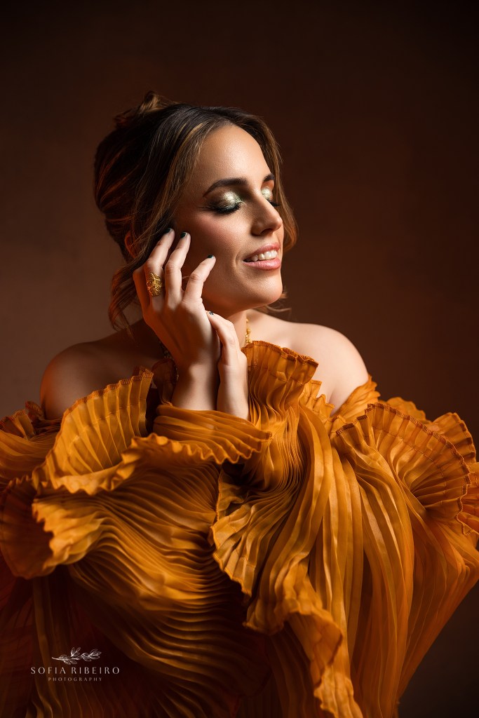 a closeup face framing portrait in beautiful tones of gold and warmth, captured by a short hill nj photographer for a 40th birthday session in nj