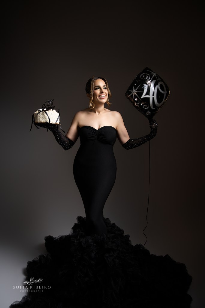 40th birthday photo shoot with cake and balloons and a dramatic black gown
