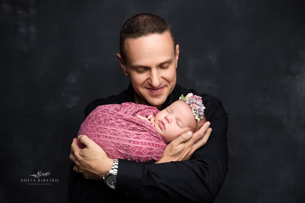 budd lake nj newborn photographer captures a smiling dad holding his newborn baby girl