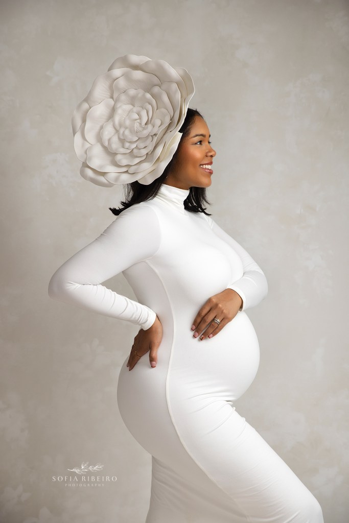 dunellen nj maternity photographer captures a high fashion pregnancy pose, with giant floral headpiece.