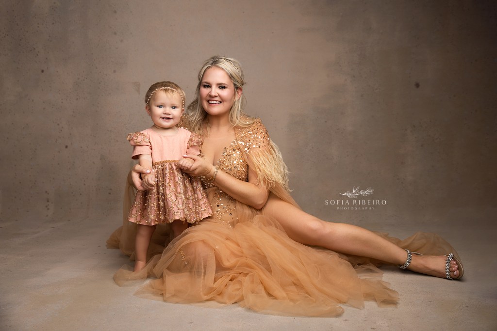 a nj motherhood photographer captures a smiling portrait of mom ad her youngest baby during a photo session