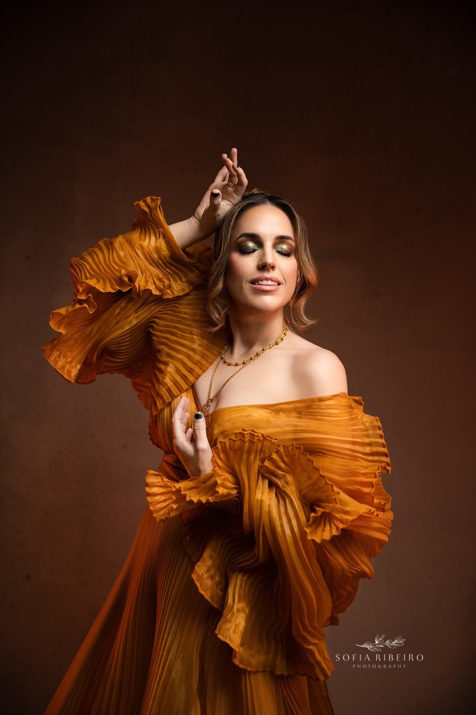 an artful pose in a gold pleated gown to celebrate a 40th birthday session in short hills nj