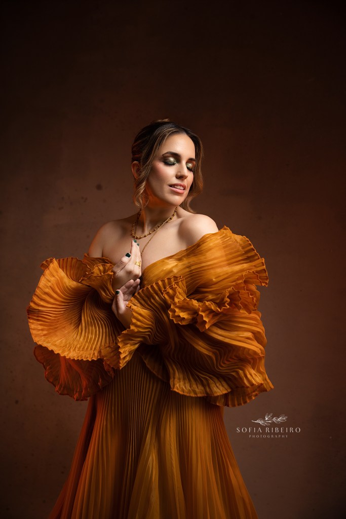 an intimate closeup portrait with dramatic flare, in gold, to celebrate a shining 40th birthday portrait session