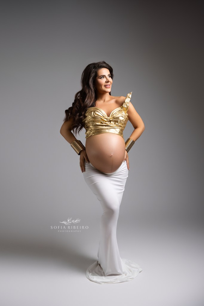 mom is a goddess in a stunning two piece gold bustier and white skirt for maternity protraits.