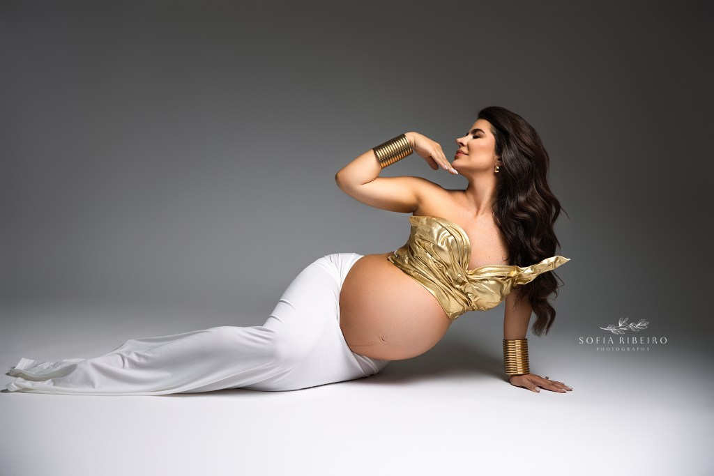 a maternity session in south jersey showcases elegance for mom to be in a two piece white and gold ensemble. 