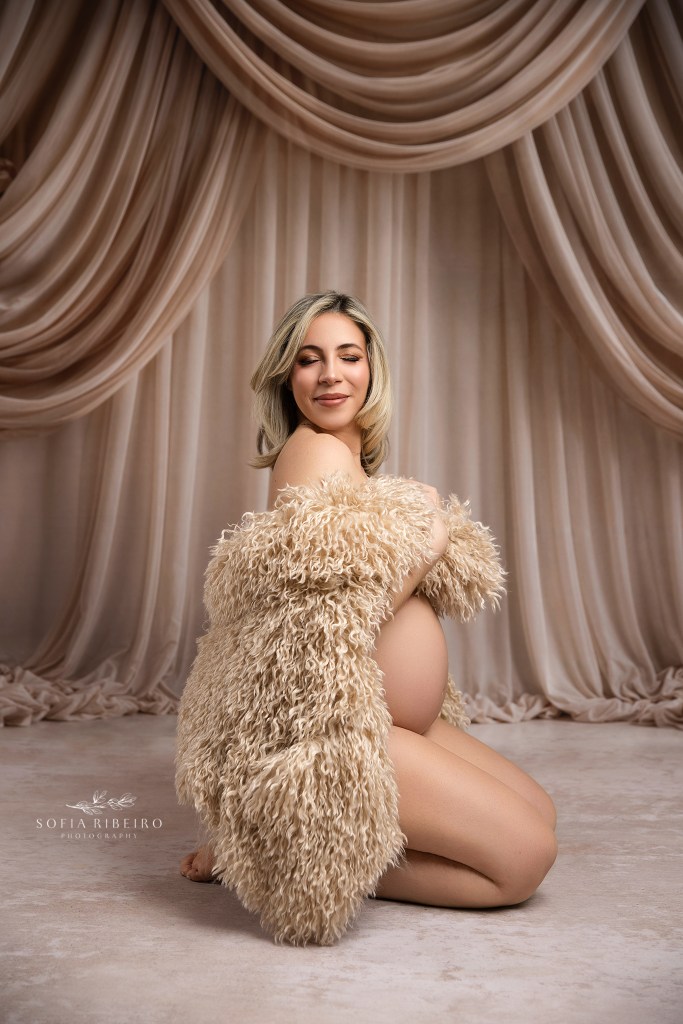 a neutral fur shawl perfectly exposes mom to be's baby bump during her maternity session in iselin nj