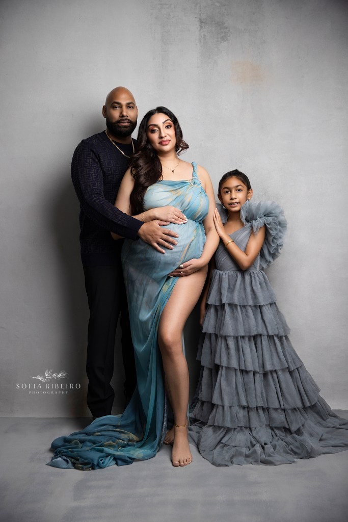 mom, dad, and big sister celebrate the coming arrival of their new baby in refined tones of grey and blue in hoboken nj