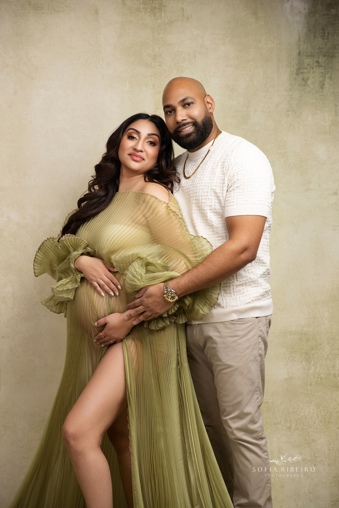 mom and dad pose together in a tender moment for their maternity portraits in jersey city