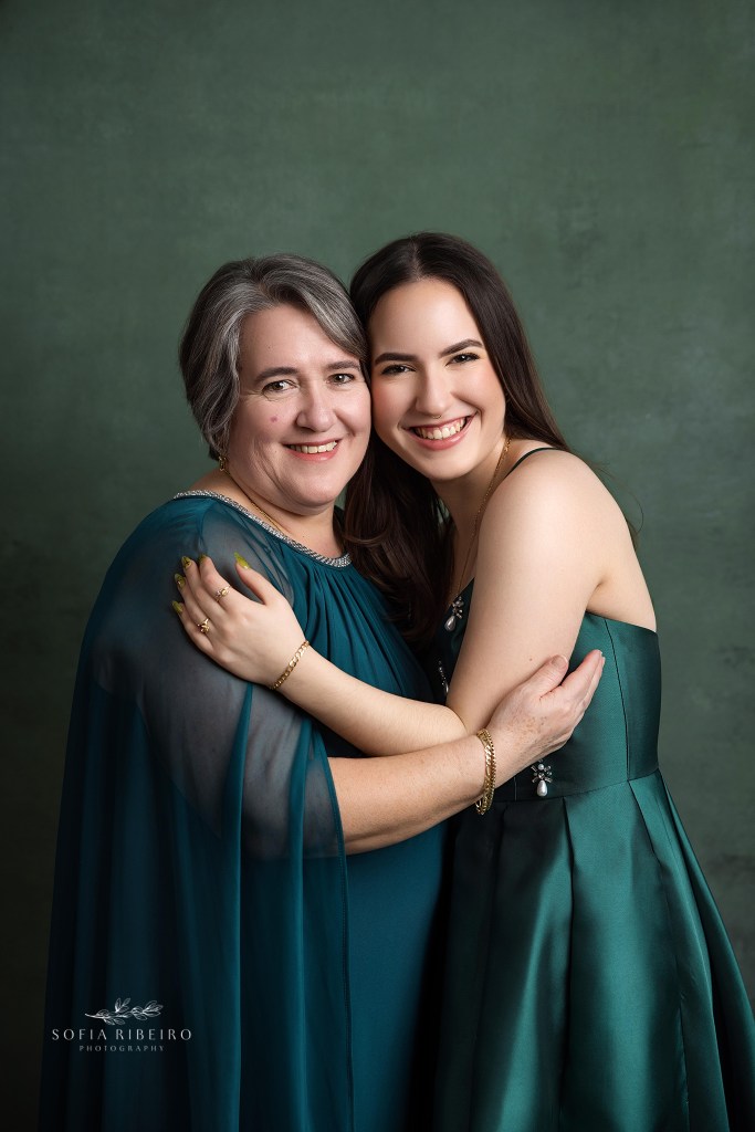 mom and daughter share a hug during photos celebrating her sweet 16