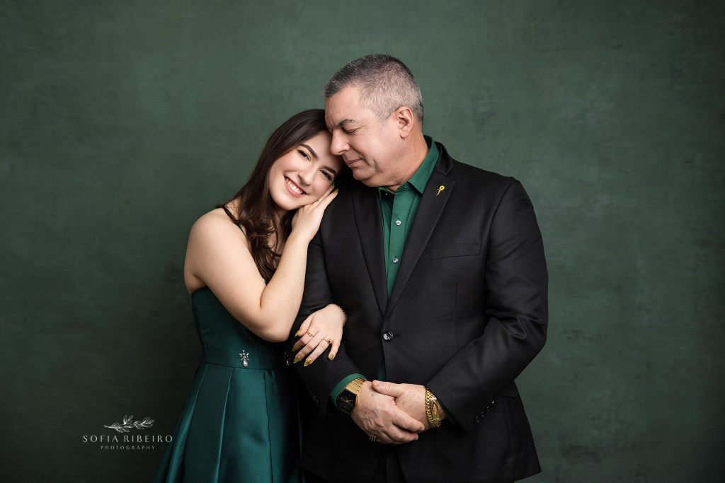 dad poses with his youngest daughter in an emotional portrait during her sweet 16