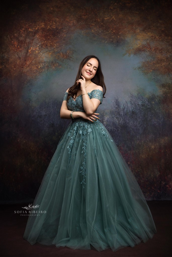 Sweet sixteen session in New Jersey featuring soft sage green tones and an elegant studio backdrop.