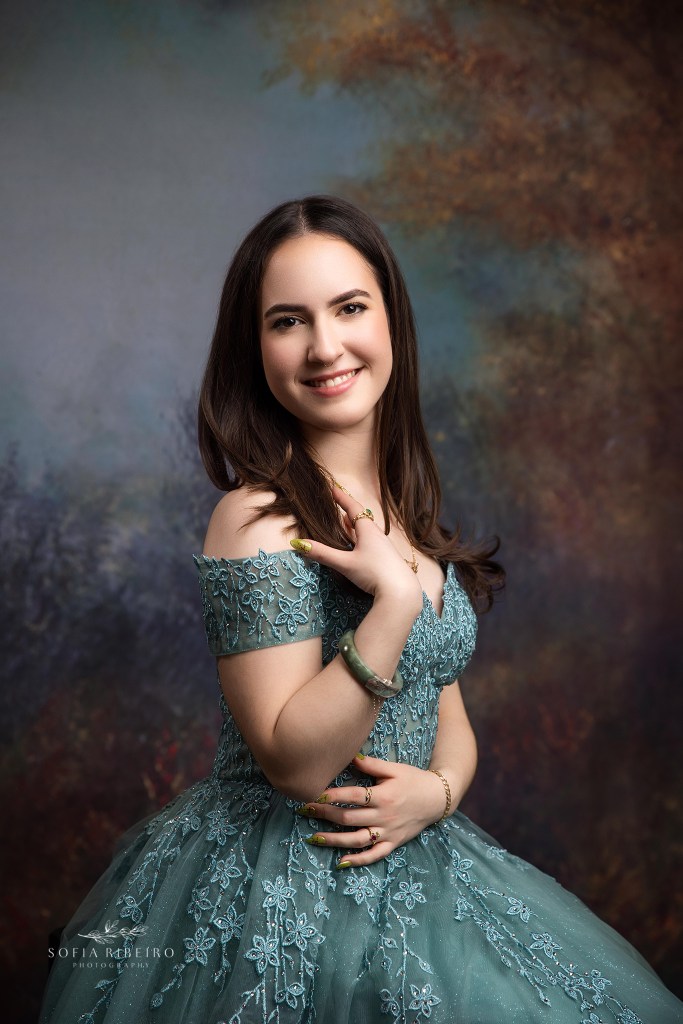 a victorian painted backdrop complements a sweet 16 gown in muted blue tones