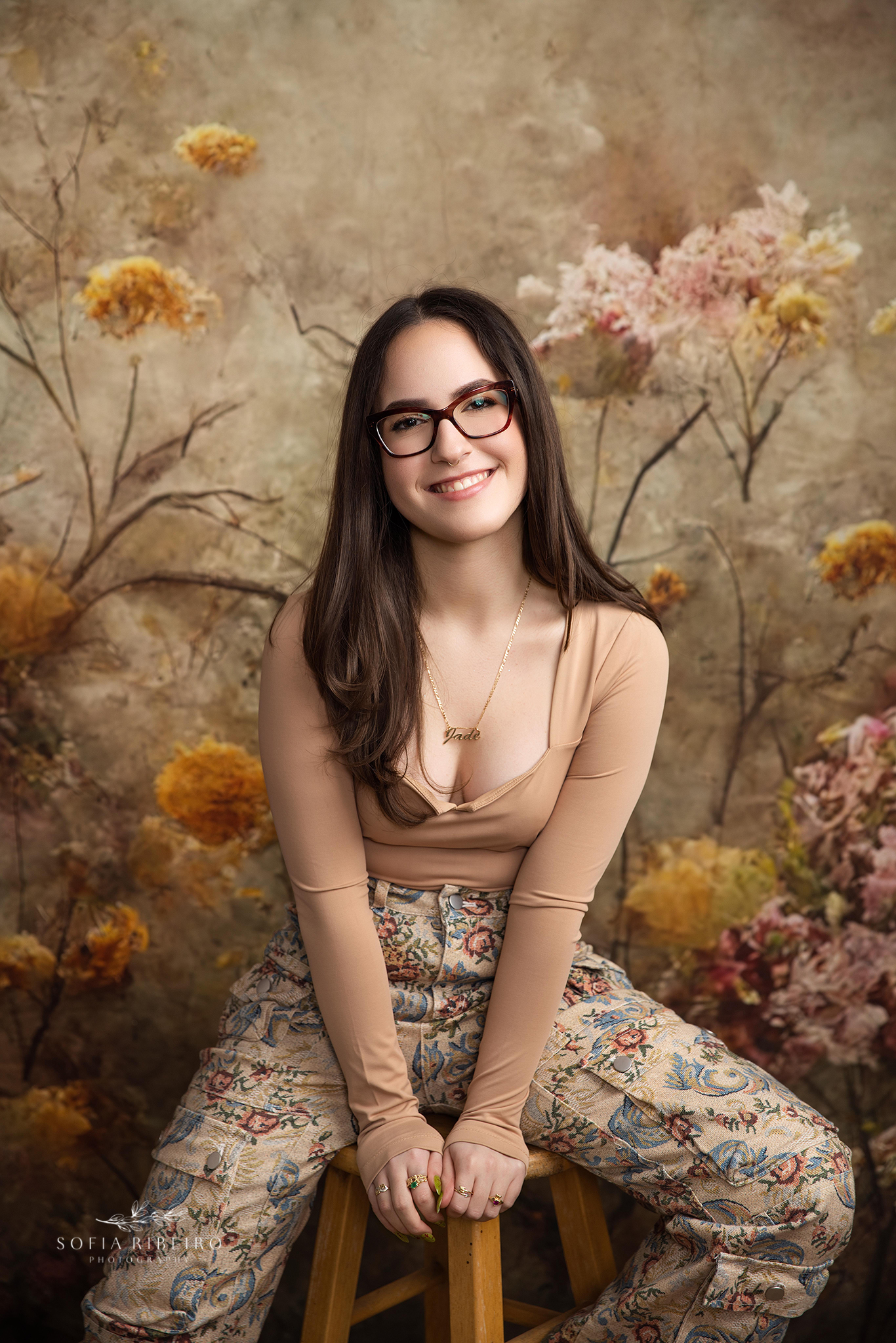 nj sweet 16 photographer captures personality portraits against a dramatic floral backdrop