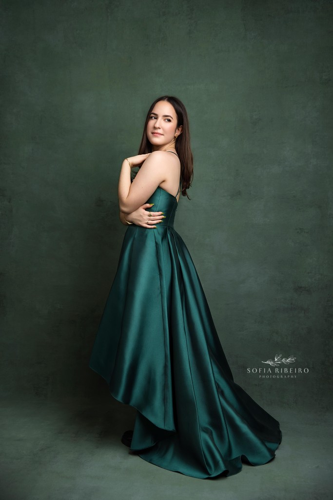 NJ sweet sixteen photography portrait of teen girl in emerald green gown surrounded by lush green backdrop