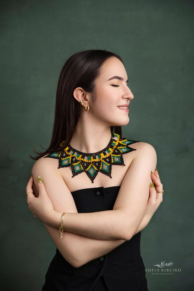 a closeup portrait of a 16 year old with a striking necklace during sweet 16 photo